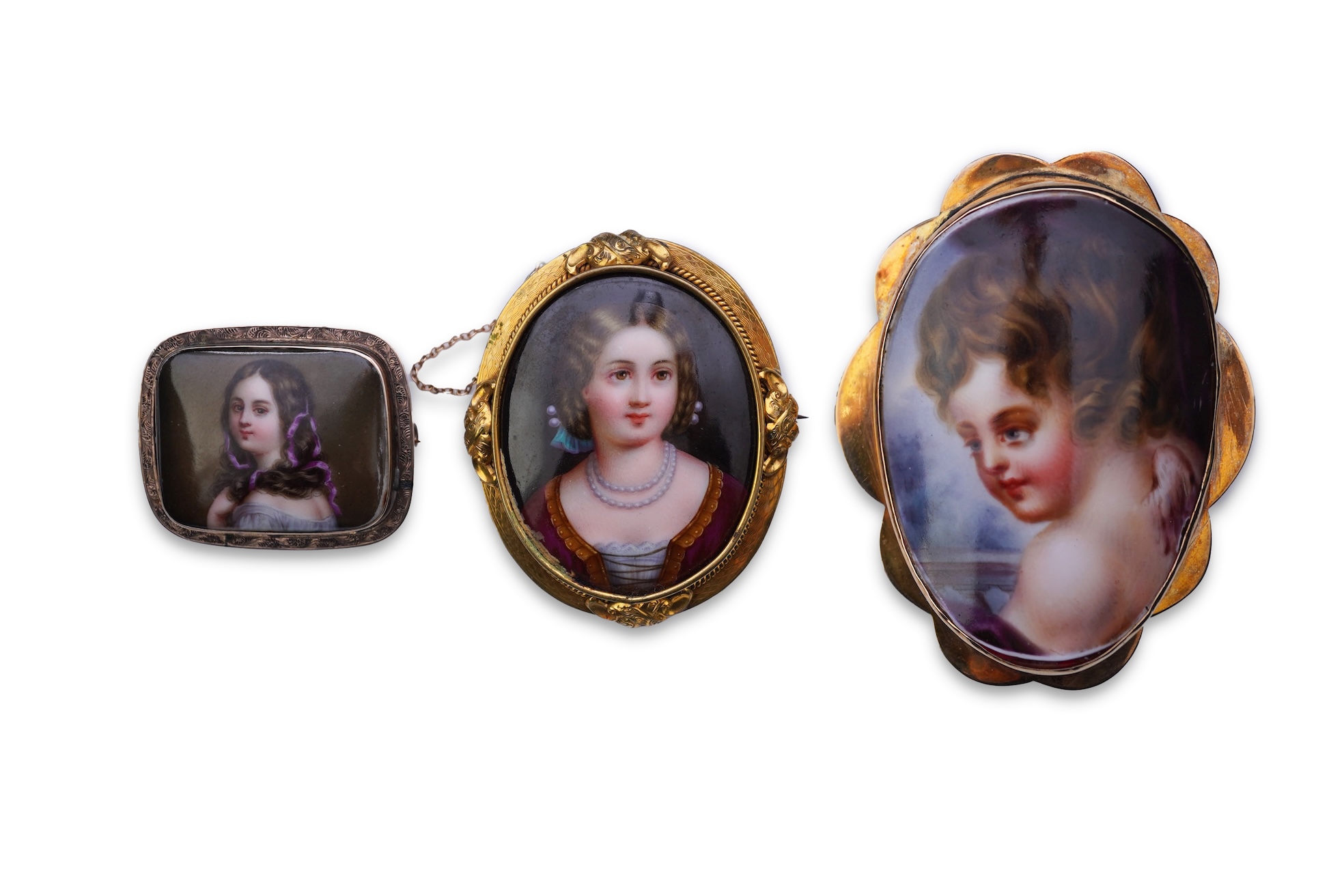 Three painted enamel brooches, mid 19th century